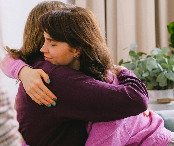Therapist hugging patient in therapy session